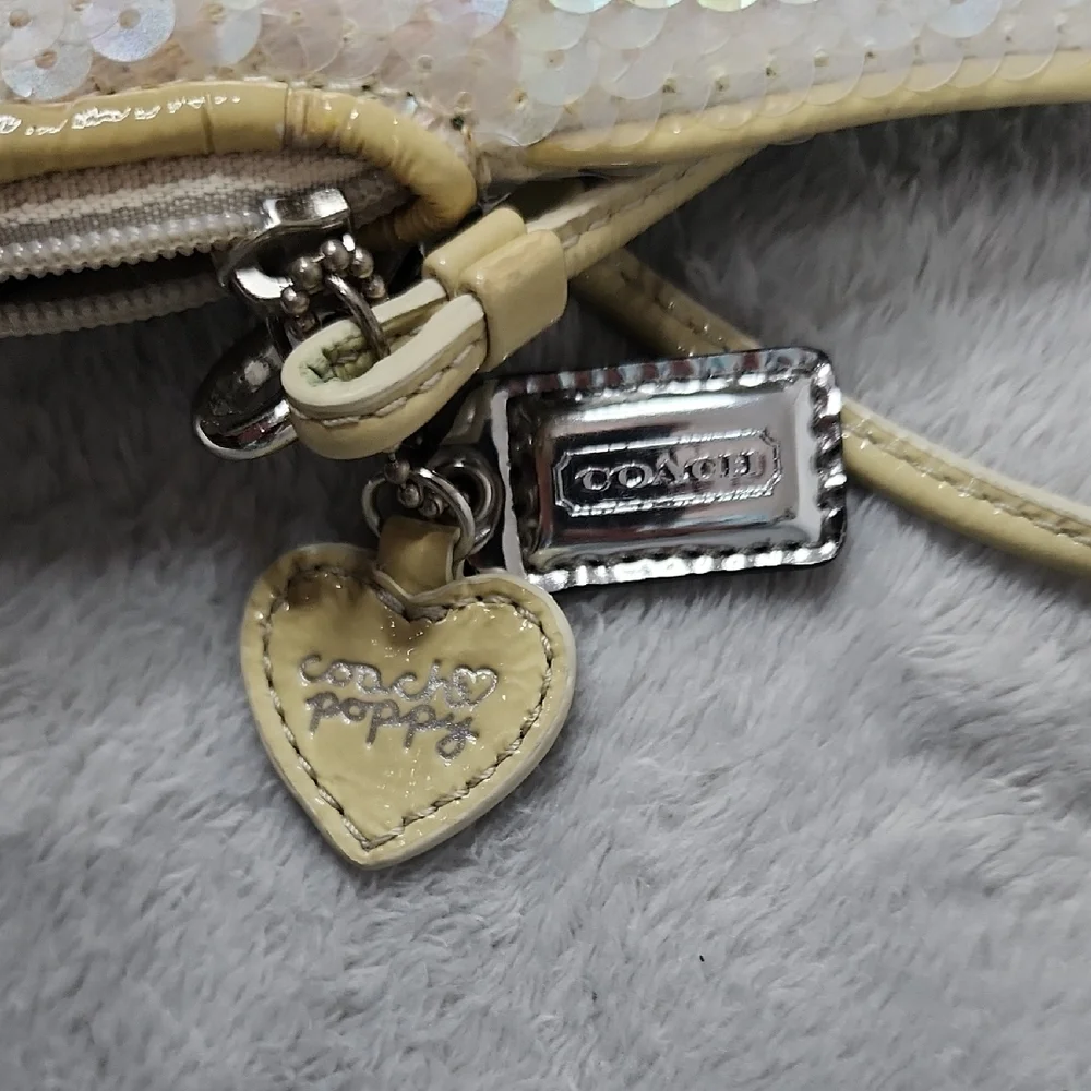 Coach Poppy vintage cream iridescent sequin small wristlet.